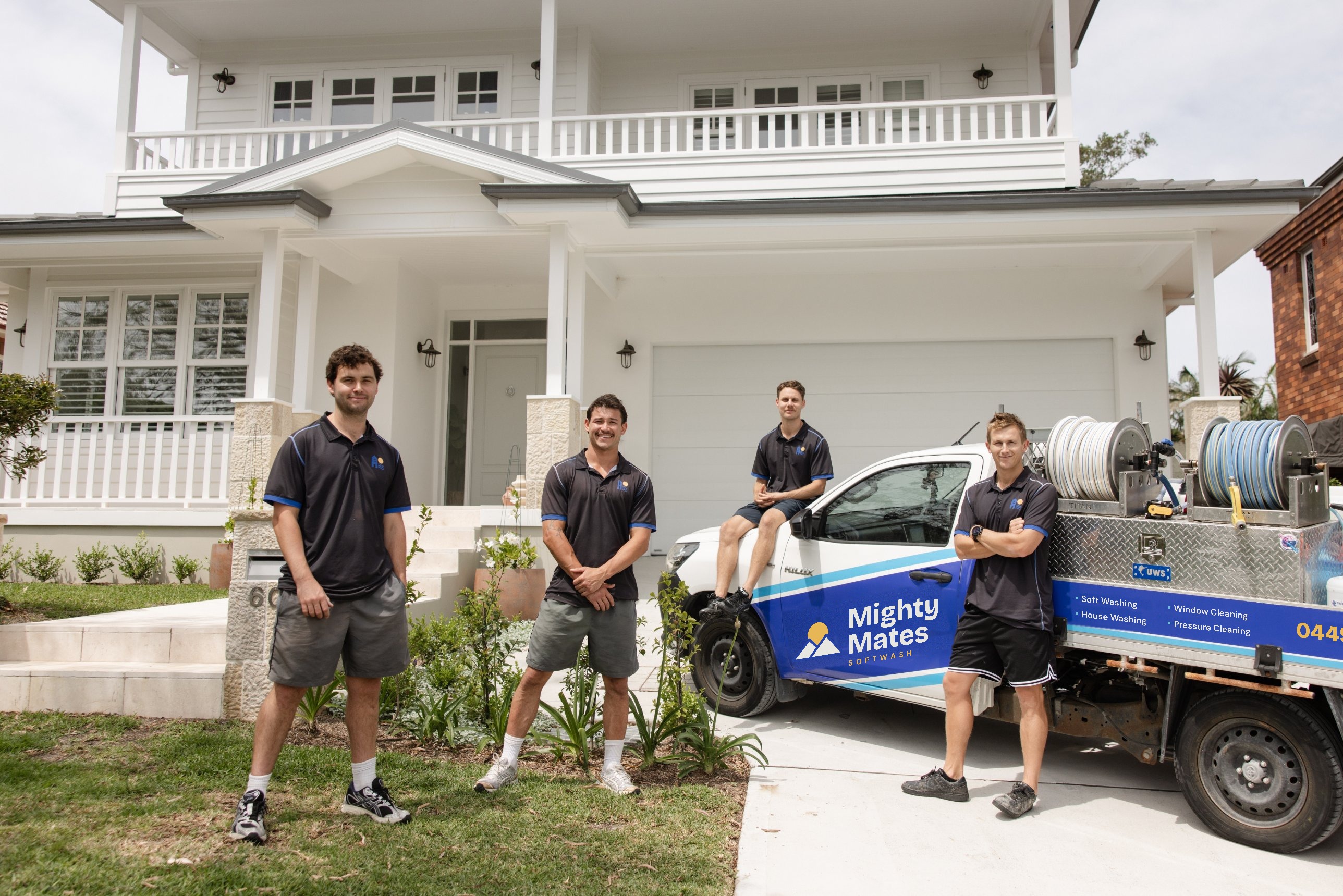 Mighty Mates Softwash team and branded truck in front of a Northern Beaches home