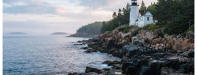 A white lighthouse on granite rocks along the Maine coast