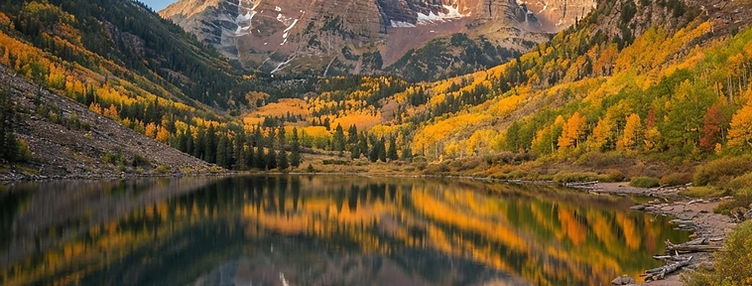 A still mountain lake beneath the Colorado peaks