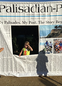 Vanessa behind the Palisadian-Post newspaper sign
