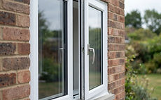 A new white uPVC double-glazed window fitted to a brick house
