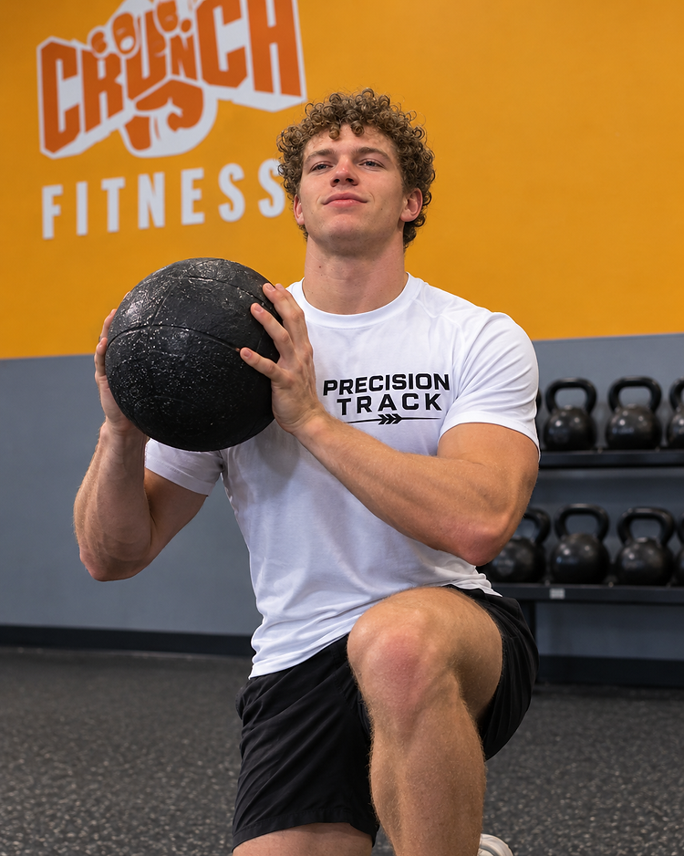 Forrest Howard, founder of Precision Personal Training, lunging with a medicine ball