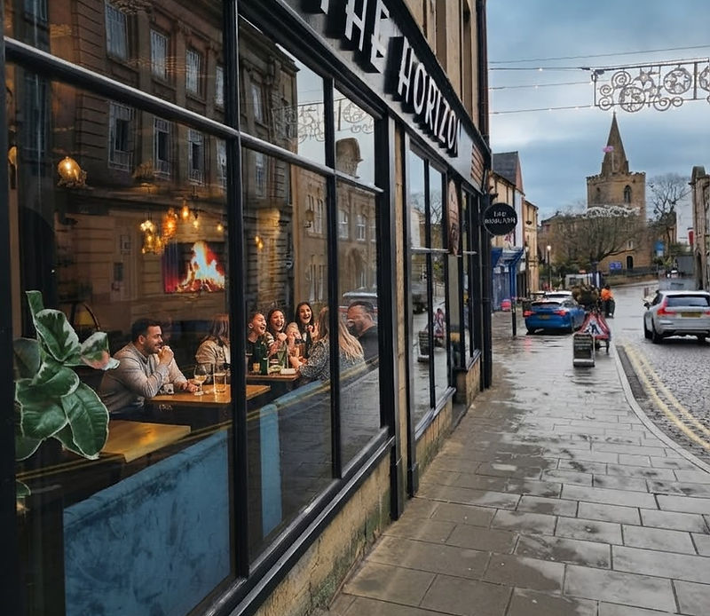 The Horizon Mansfield shopfront on Church Street, with diners at the window and the church beyond