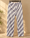 Back view of the sage stripe pleated trousers on a hanger