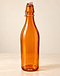 Amber glass swing-top bottle on limestone