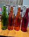Green, amber, orange and red glass swing-top bottles