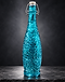 Turquoise textured glass swing-top bottle on slate