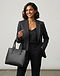 Minimalist Leather Handbag - Black (Black), worn or held by model