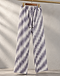 Sage stripe pleated trousers hanging on a wooden hanger