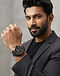 Chronograph Watch - Black/Gold (Black), worn or held by model