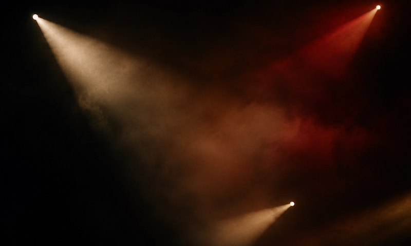 Beams of light through theatre haze
