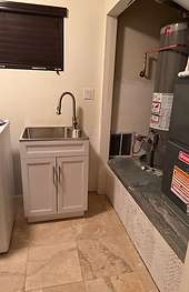 New utility sink cabinet with pull-down faucet installed in the laundry room