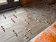 Wood-look tile floor being installed with levelling clips