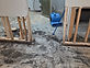 Flood-damaged basement with drywall removed and air mover running
