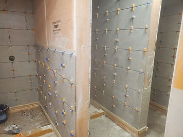 Shower tile installation over waterproofing membrane