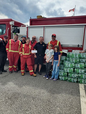 Donation presented to the Labrador City Fire Department beside a fire truck