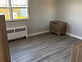 Renovated bedroom with new paint and vinyl plank flooring
