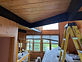 Wood ceiling and dark beams being refinished
