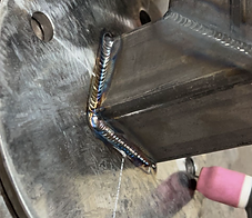 Close-up of clean, evenly stacked TIG weld beads on a steel joint