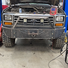Custom heavy-duty steel front bumper fabricated and welded for a work pickup truck
