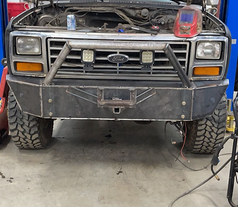 Custom heavy-duty steel front bumper fabricated and welded for a work pickup truck