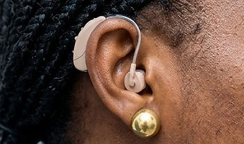 A patient wearing a behind-the-ear hearing aid