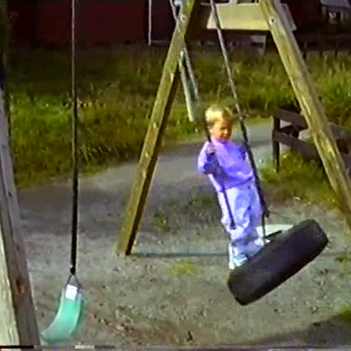 Album cover: a child on a swing