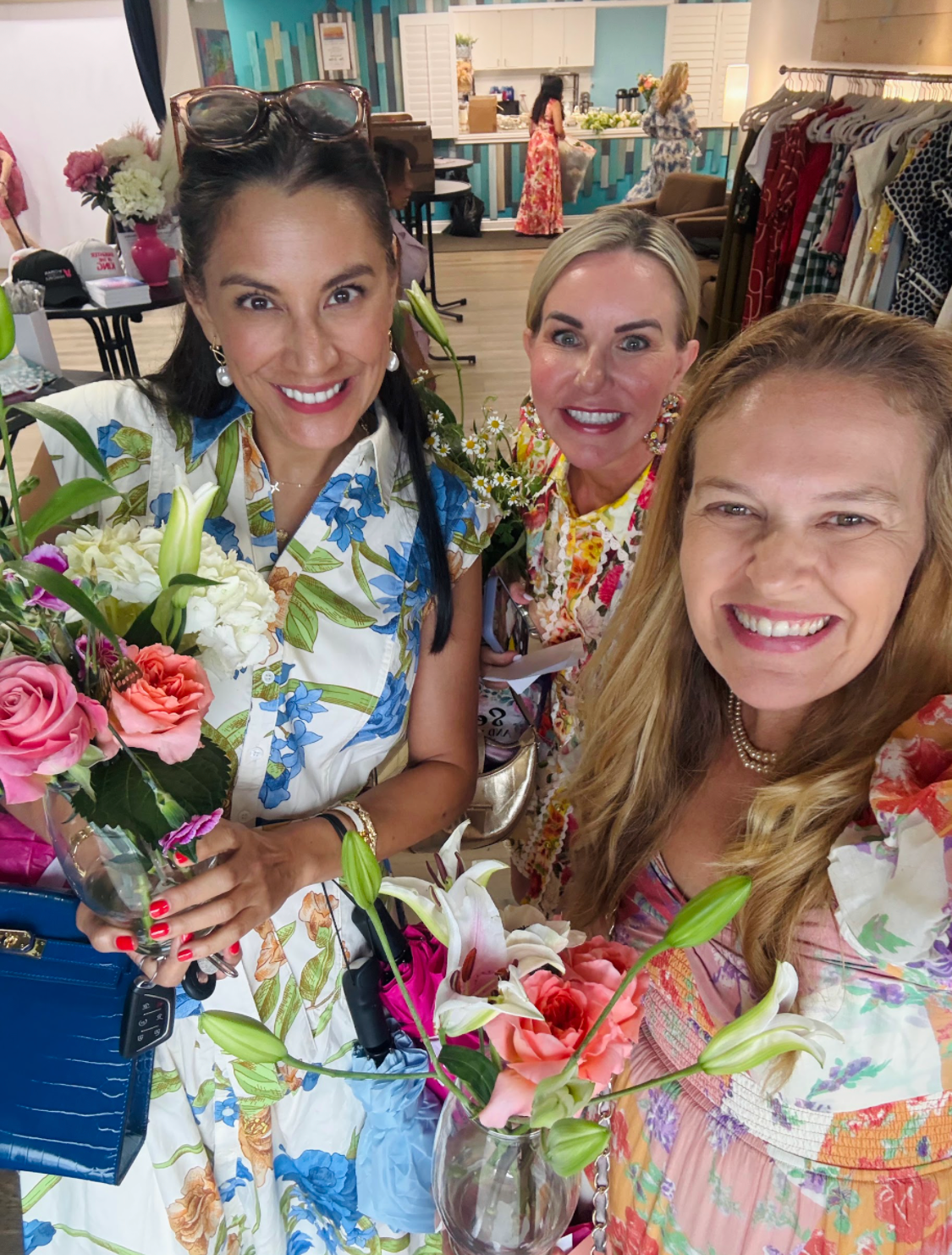 Women smiling with flowers at The Presence You Bring