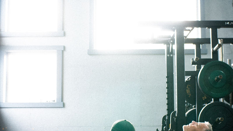 Coach guiding an athlete through a lift