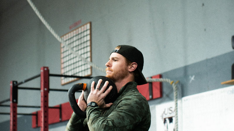 Athlete holding a kettlebell in a goblet squat position