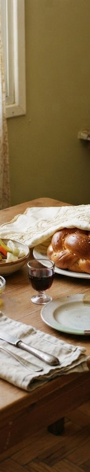 A Shabbat table being set in a home