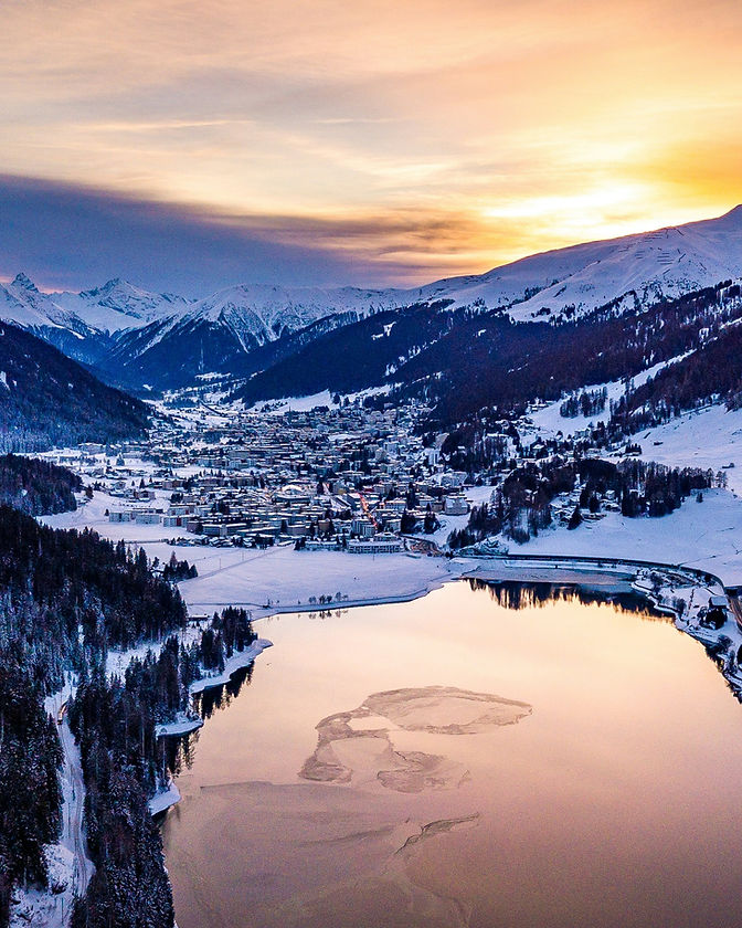 Davos at twilight, the town and lake beneath the surrounding mountains
