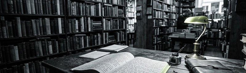 A warm independent bookshop with an open manuscript on a desk