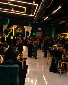 Guests gathered beneath the House of Events logo wall