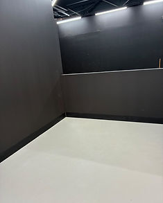 A corner of the venue showing the black walls and polished floor