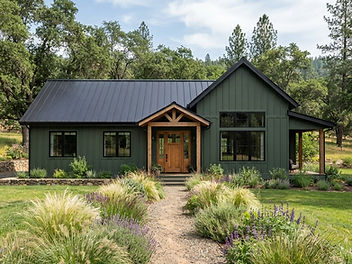 Modern farmhouse painted deep forest green with board and batten siding, black window frames, black gutters and a black standing seam metal roof, a wooden front door and ornamental grasses along a gravel path