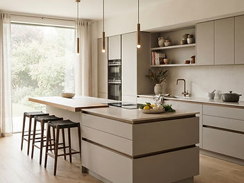 Modern true handleless kitchen in warm greige matt finish with slim recessed channels, an island with an oak worktop, bar stools, slender pendant lights and a large garden window