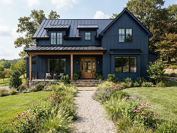 Navy blue modern farmhouse with board and batten siding, black window frames, a black metal roof, a natural wood front door and porch beams and a gravel path through ornamental grasses