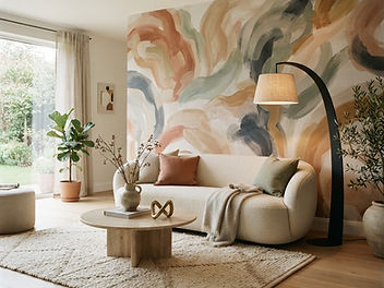 Contemporary living room with an abstract painterly mural wallpaper in terracotta, sand, sage and charcoal brushstrokes behind a curved cream boucle sofa, a round travertine coffee table and an arched floor lamp