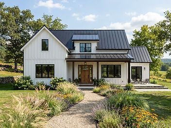 White modern farmhouse with board and batten siding, black window frames, a black standing seam metal roof, a natural wood front door and a gravel path through ornamental grasses