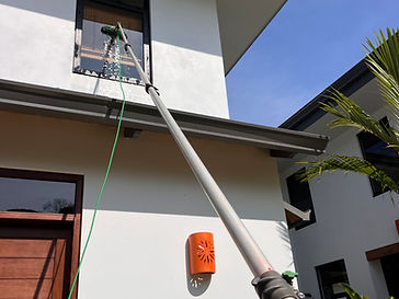 Water-fed pole cleaning on a tropical home