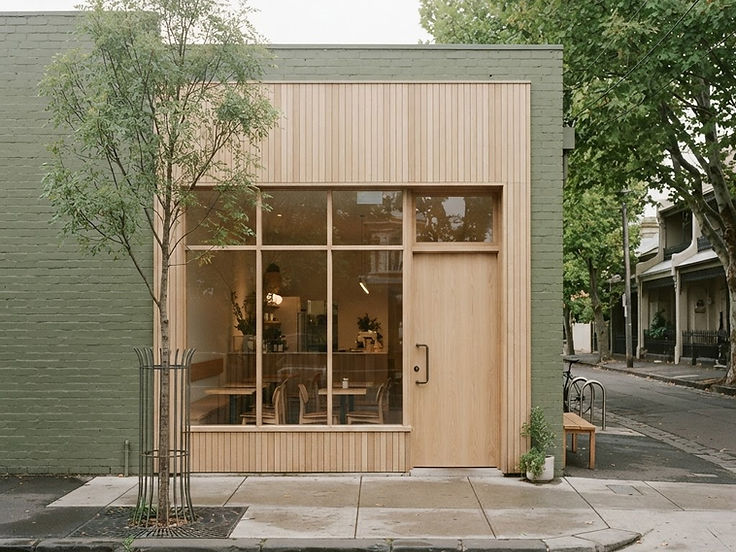 The pale oak and glass frontage of KISSA on a quiet Melbourne street