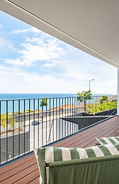 Balcony lounge chairs facing the Atlantic