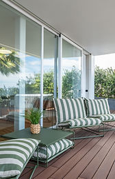 Long balcony with glass doors and jacuzzi reflection