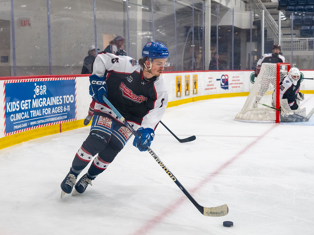 Southern Puck player skating with the puck toward the net
