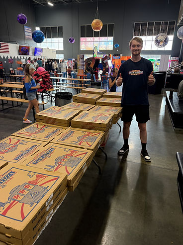 Aidan with pizza boxes ready for an event