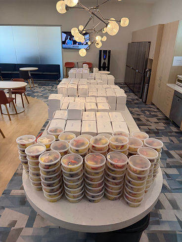 Boxed lunches and fresh fruit cups ready for pickup