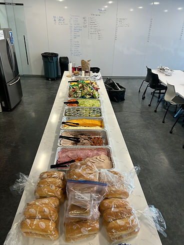 Sub sandwich bar with meats, cheeses, and fresh rolls