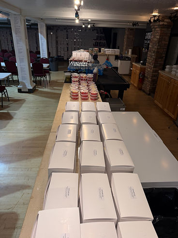 Boxed lunches and fruit cups set up in a venue