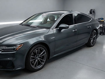Car with dark ceramic window tint on the side and rear glass